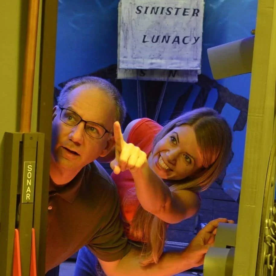 Two players pointing excitedly inside the 20,000 Leagues Under the Sea escape room